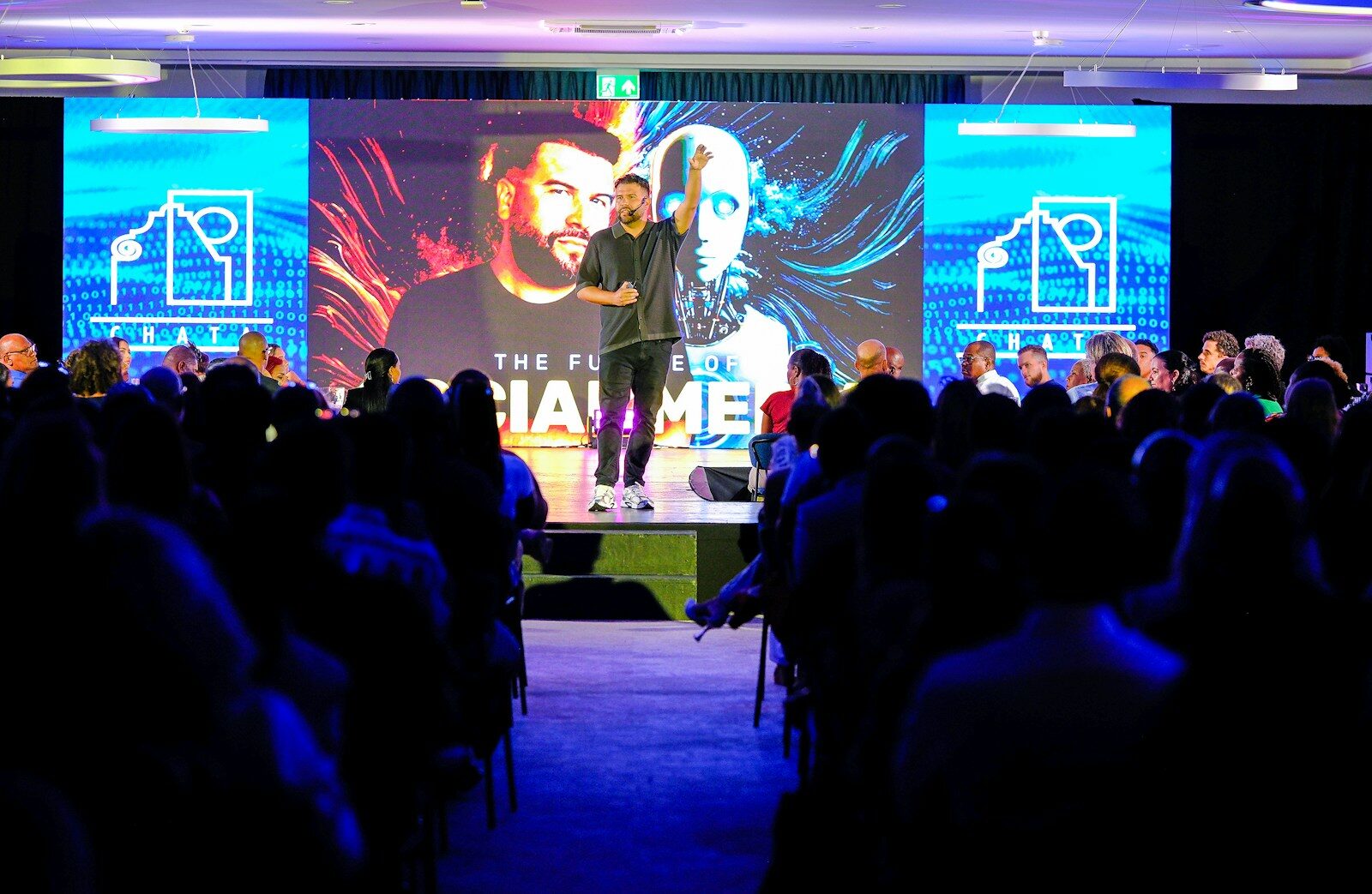 Speaker presenting on stage to an audience